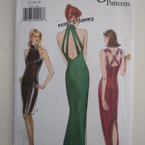 May include: A Vogue Patterns sewing pattern envelope 9400 featuring illustrations of three sleeveless dresses. Dress A is black and knee-length. Dress B is a floor-length green gown with a high neck and open back. Dress C is a floor-length maroon gown.