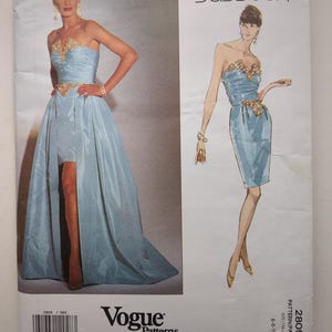 May include: A Vogue Patterns Designer Original sewing pattern envelope for Bellville Sassoon design 2805, size 6-8-10. The cover features a light blue strapless dress with gold embellishments at the bodice and waist, shown as a photo and illustration.