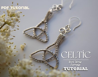 May include: A pair of silver-toned Celtic wire wrap earrings. The earrings feature a Celtic knot design and are displayed on a light gray surface with white flowers. Text on the image reads "PDF Tutorial" and "Celtic Wire Wrap Earrings Tutorial."