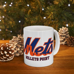 May include: White ceramic mug with a blue and orange New York Mets logo and the text "Willets Point".