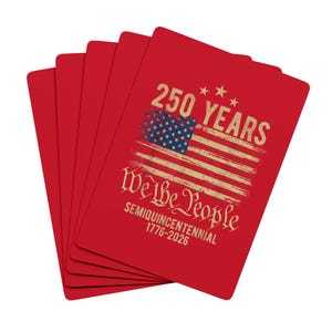 May include: A fanned deck of red playing cards. One card displays a distressed American flag design with the text "250 YEARS" and "We the People" in gold lettering. The bottom of the card reads "SEMIQUINCENTENNIAL 1776-2026".