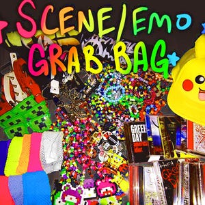 May include: A vibrant collection of scene/emo accessories and merchandise. Includes a yellow Pikachu hat, bracelets, CDs, and various colorful items. The words "SCENE/EMO GRAB BAG" are written in rainbow colors.