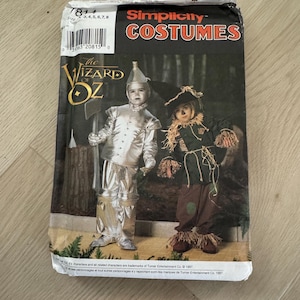 May include: Simplicity Costumes pattern for The Wizard of Oz. The package features images of the Tin Man and Scarecrow costumes. The package includes sizes 3, 4, 5, 6, 7, and 8.