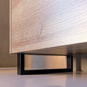 May include: A wooden cabinet with a light brown finish and black metal legs. The cabinet has a simple, modern design.