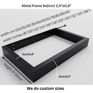 May include: A rectangular black metal frame with dimensions labeled as 6x2cm or 2.4"x0.8". The frame features pre-drilled holes on the inner side. Text indicates available widths from 20-91cm or 8"-36", a height of 8"/20cm, and that custom sizes are available.