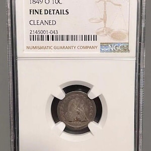 May include: A silver coin from 1849, graded by Numismatic Guaranty Company. The coin is encased in a clear plastic holder with the text "1849 O 10C FINE DETAILS CLEANED". The coin's details are visible, and the holder has a barcode and NGC logo.