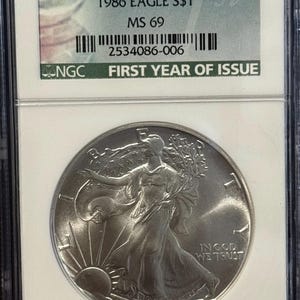 1986 P American Silver Eagle ASE • Key Date • Philadelphia Mint • First Year of Issue Label • 1 oz 99.9% Pure Silver • Graded NGC MS69