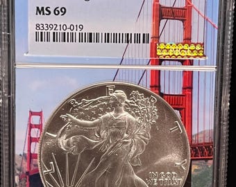 1987 S American Silver Eagle (ASE) • Struck at San Francisco Mint • RARE Golden Gate Bridge Slab Core Label • 1 oz Fine Silver • NGC MS69