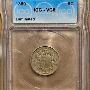 1869 Shield Nickel • MINT ERROR, Laminated (Delamination Flaw) • Graded ICG VG8