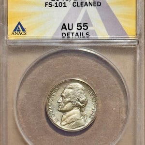 May include: A 1943-P 5C Jefferson nickel graded AU 55 by ANACS, encased in a protective holder. The coin features a profile of Thomas Jefferson and the inscription "IN GOD WE TRUST". The holder displays the grade and details.