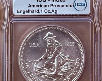 1985 Engelhard American Prospector Vintage Silver Round • 1 oz Fine Silver (99.9% Pure) • Flag Label • Eagle Reverse • Graded ICG MS69