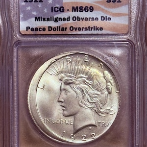 Dollaro Peace in argento del 1922, sovrastampa di Daniel Carr • Errore di conio, conio disallineato • Moneta fantasy • Classificazione ICG MS69