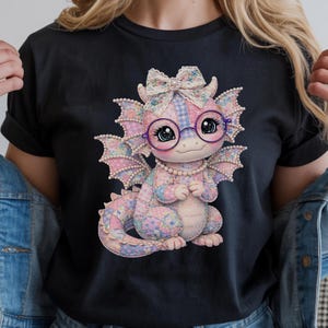 May include: Black t-shirt with a colourful dragon illustration. The dragon wears glasses, a bow, and a pearl necklace. The dragon's scales are pink, purple, and blue patchwork. The shirt has a round neck and short sleeves.