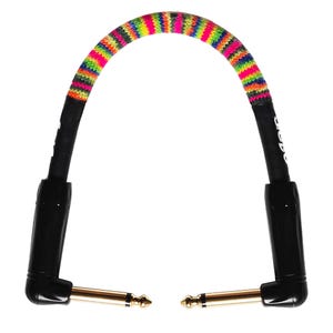 May include: A colorful instrument cable with a rainbow-patterned fabric sleeve. The cable has black connectors with gold-colored tips. The cable is designed to connect musical instruments to amplifiers or other audio equipment.