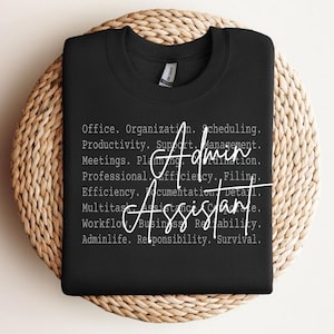 May include: A white ceramic mug with a black handle and the text "But First, Coffee" in a bold, black font. The mug is set against a blurred background, suggesting a cosy setting.