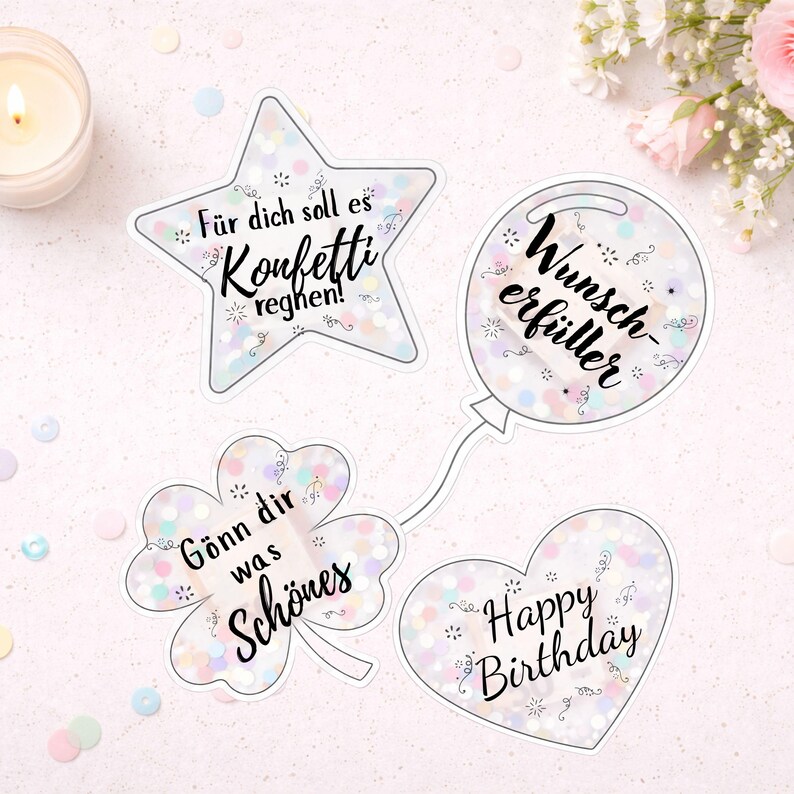 Pu&ograve; includere: Quattro adesivi decorativi a forma di stella, palloncino, quadrifoglio e cuore. Ogni adesivo ha un bordo bianco e contiene coriandoli. La stella dice "F&uuml;r dich soll es Konfetti reghen!". Il palloncino dice "Wunscherf&uuml;ller". Il quadrifoglio dice "G&ouml;nn dir was Sch&ouml;nes". Il cuore dice "Happy Birthday".