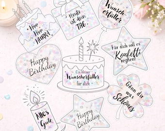 May include: A collection of outlined birthday-themed stickers with various shapes, including cakes, a gift box, a heart, a star, a balloon, a candle, and a four-leaf clover. Each sticker has text in a script font, such as "Happy Birthday" and "Alles Gute."