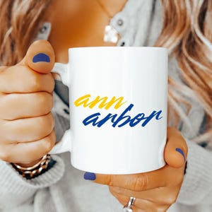 Ann Arbor Coffee Mug Maize Blue Script Font Ceramic Cup Michigan College Town Gift for Wolverines Students Alumni Game Day Tailgate Fans