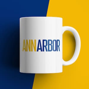 Ann Arbor Coffee Mug Blue Maize Michigan Colors Bold Font Ceramic Cup College Town Gift for Wolverines Fans Alumni Students Game Day