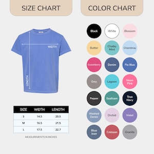 May include: A light blue t-shirt with a size chart and color chart. The size chart shows measurements in inches for sizes S, M, and L. The color chart displays various colors, including black, white, and pink.