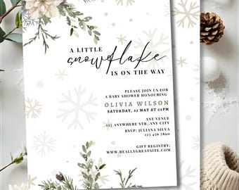 May include: Baby shower invitation with a snowflake theme. The invitation features the text "A little snowflake is on the way" with details for Olivia Wilson's baby shower. The design includes snowflakes, floral accents, and event details.