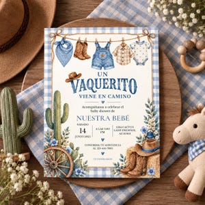 May include: A baby shower invitation card featuring a western theme with a clothesline displaying a blue bandana, brown boots, denim overalls, a plaid shirt, and a polka dot onesie. The text reads UN VAQUERITO VIENE EN CAMINO, NUESTRA BEBÉ, and event details.