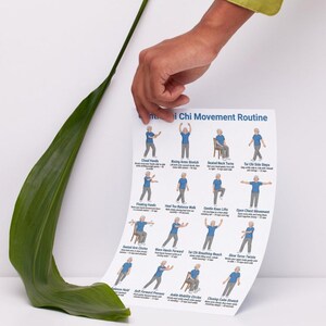 May include: A poster titled "Tai Chi Movement Routine" with illustrations of Tai Chi exercises, held by a hand. The poster shows various movements with accompanying text, including "Cloud Hands" and "Rising Arms Stretch".