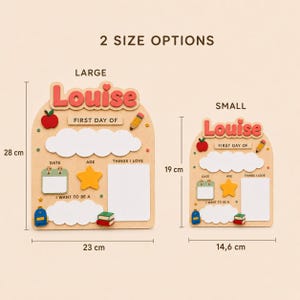May include: Two wooden school-themed signs labeled Louise with blank spaces for date, age, and interests. The large sign measures 28 cm by 23 cm, and the small sign measures 19 cm by 14.6 cm. Both feature colorful icons of an apple, pencil, star, calendar, backpack, and books.