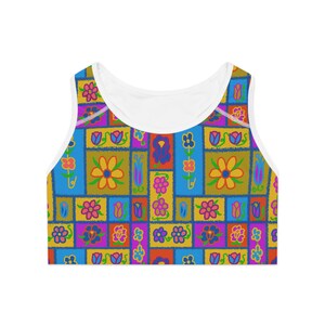 May include: A colorful crop top with a patchwork design featuring flowers and leaves in shades of blue, yellow, pink, green, and orange.