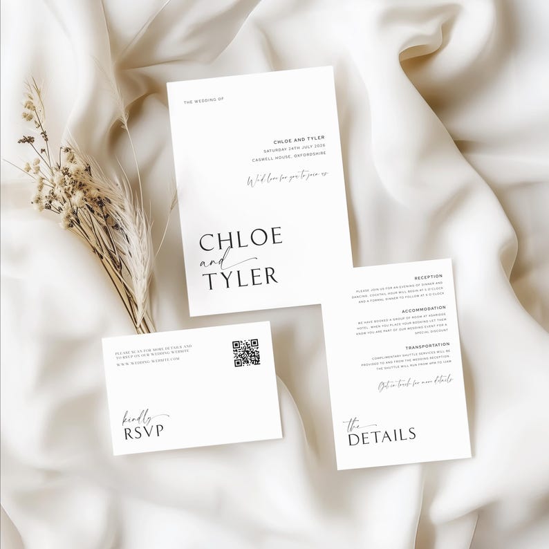 Flat lay of a wedding invitation suite styled with greenery and soft fabric for an elegant, minimalist aesthetic.