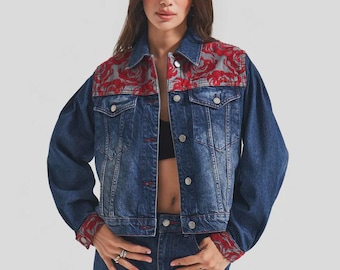 May include: A denim jacket with red floral embroidery on the shoulders and cuffs. The jacket has a classic button-up design and is paired with matching denim jeans. The outfit is a stylish combination of casual and decorative elements.