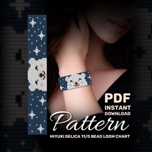 May include: A beaded bracelet with a polar bear design. The bracelet is primarily navy blue with white stars and a white polar bear face. The image also includes the text "PDF Instant Download Pattern".