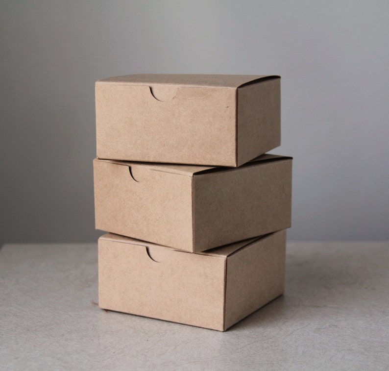 3 Brown kraft gift boxes stacked on top of one another.