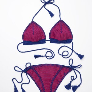 May include: A pink and blue crochet bikini with tassel ties. The top is a triangle style and the bottom is a cheeky style.