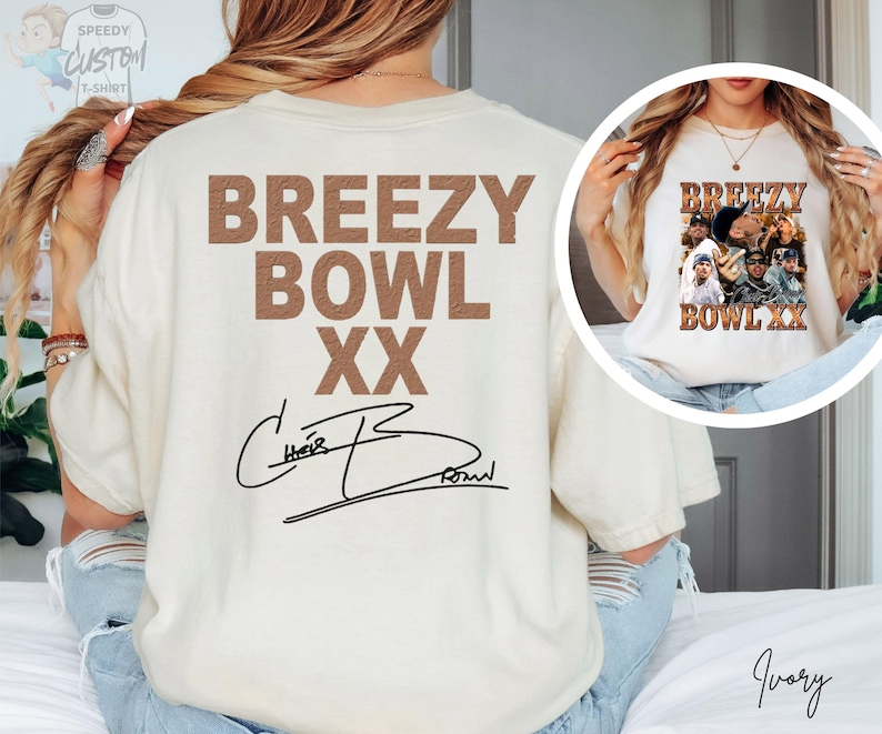 a person wearing a white t-shirt with the text "BREEZY BOWL XXX" printed on it, along with a signature. The person is also wearing a necklace and has their hair styled in braids.