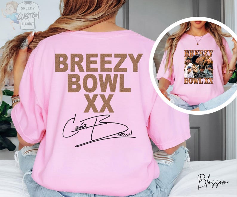 A woman wearing a pink t-shirt with the text "BREZZY BOWL XX" printed on it, along with a signature.