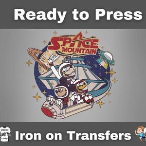May include: Iron on transfer featuring a vintage-style graphic of Mickey Mouse, Goofy, and Donald Duck in space suits on the Space Mountain ride. The design includes a planet, stars, and a flying saucer. Text at the top reads "Ready to Press" and at the bottom "Iron on Transfers".