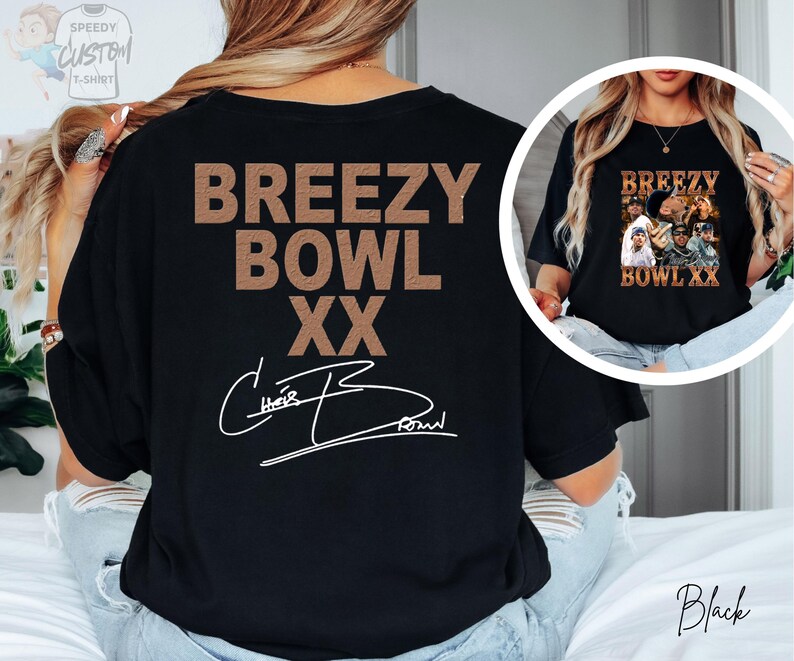 a person wearing a black t-shirt with the text "BREEZY BOWL XXX" printed on it.