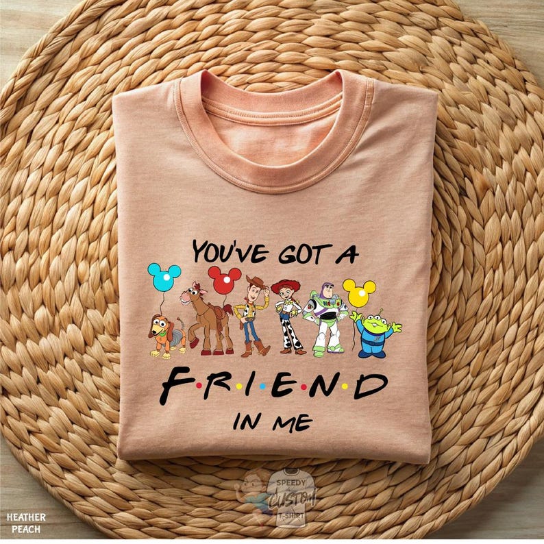 A t-shirt with a graphic design featuring characters from the animated TV series "Friends" and the text "You've Got a Friend in Me".