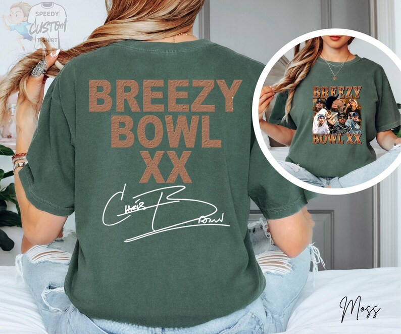 a person wearing a green t-shirt with the text "BREEZY BOWL XX" printed on it.