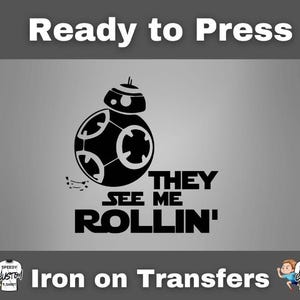 May include: Black and white graphic of a BB-8 droid with the text "THEY SEE ME ROLLIN'" on a gray background. The words "Ready to Press" and "Iron on Transfers" are also displayed.
