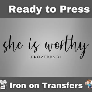 May include: A gray iron-on transfer with the words "she is worthy" in a flowing script, with "PROVERBS 31" below. The phrase "Ready to Press" is at the top, and "Iron on Transfers" is at the bottom.