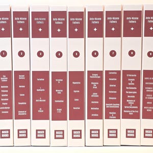 May include: A collection of nine hardcover books titled "Ante-Nicene Fathers." Each book has a white spine with burgundy text and a star or number. The series is published by "Based Books."