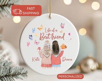 May include: A white ceramic ornament with the text "Life of a Best Friend" and illustrations of two friends and butterflies. The ornament has a gold string for hanging and the names "Kate" and "Diana" are printed below the illustrations.