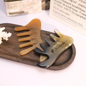 May include: A white ceramic mug with a black handle and the text "But First, Coffee" in a handwritten style. The mug is on a white surface. The mug is 4 inches tall.