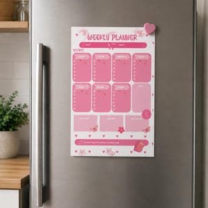 May include: A magnetic weekly planner sheet with a pink color scheme, featuring sections for each day of the week, a notes area, and additional boxes for reminders. The design includes butterfly, flower, and heart graphics with the text Weekly Planner.