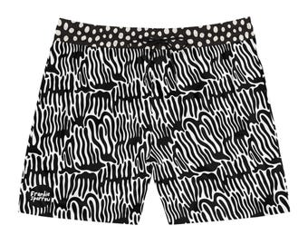 May include: Black and white patterned shorts with a drawstring waist. The shorts feature a repeating abstract design and a polka dot waistband. The brand name "Frankie Sparrow" is printed on the lower left side.