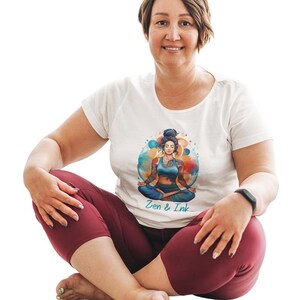 T-shirt with design of woman with tattoos sitting in yoga pose