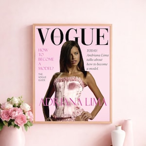 May include: A framed Vogue magazine cover featuring Adriana Lima. The cover is predominantly pink with the Vogue logo in black. Text includes "How to Become a Model?" and "Adriana Lima talks about how to become a model."