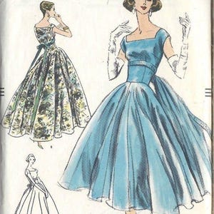 May include: Vintage Vogue sewing pattern featuring illustrations of elegant dresses. The cover displays a blue dress with a square neckline and a full skirt, alongside a floral print dress and a line drawing. The text "VOGUE" is prominently displayed.
